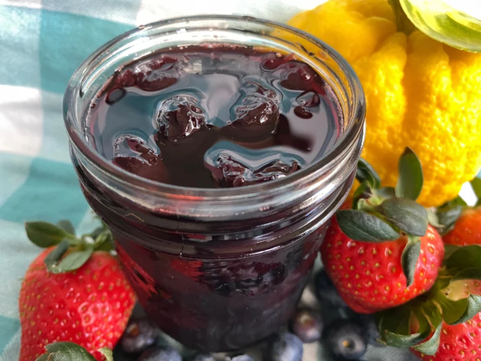 Jar of authentic sour cherry jam from BiBifood.com with vibrant red hue.